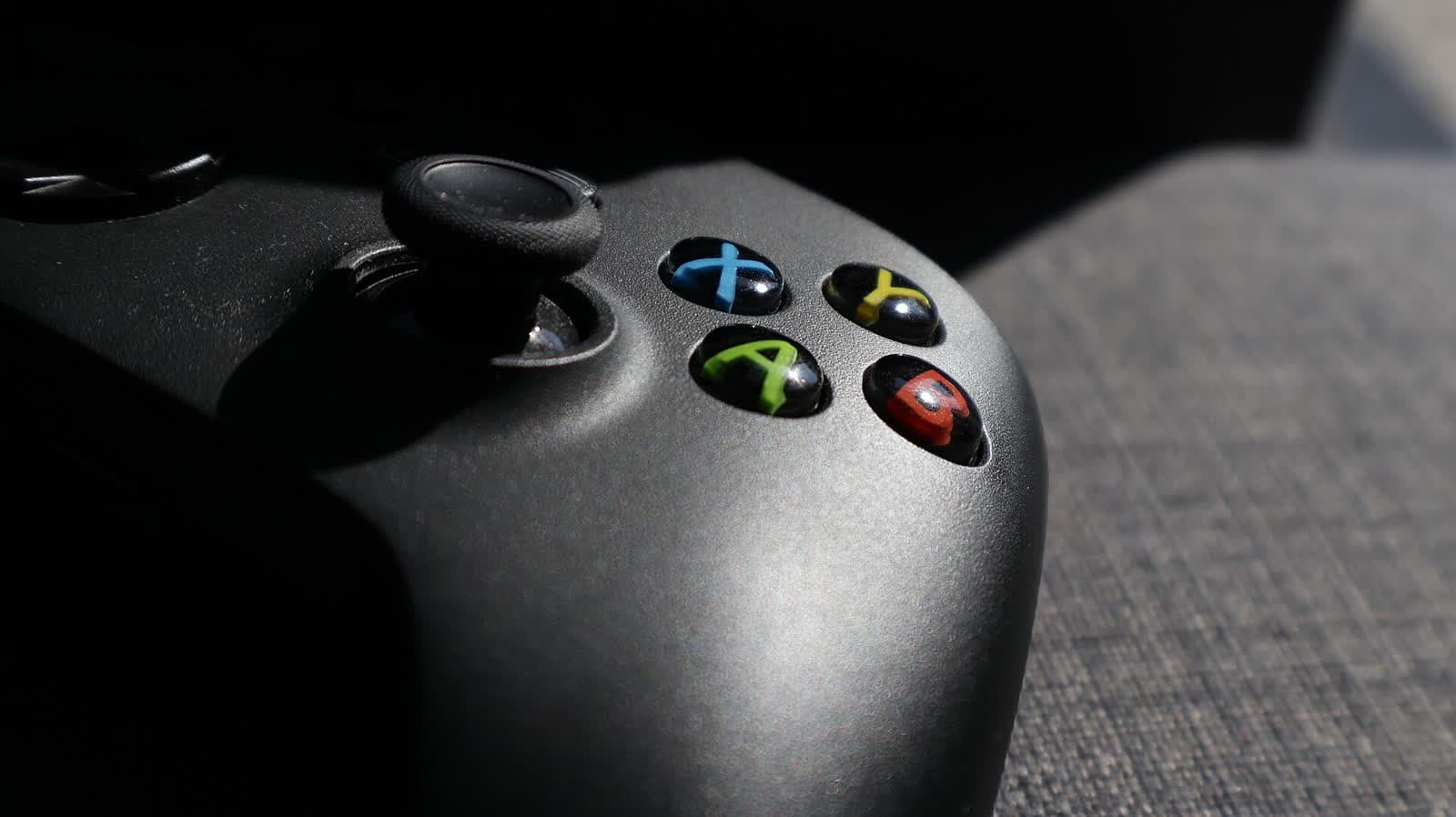 Close-up of a black game controller in dramatic side light